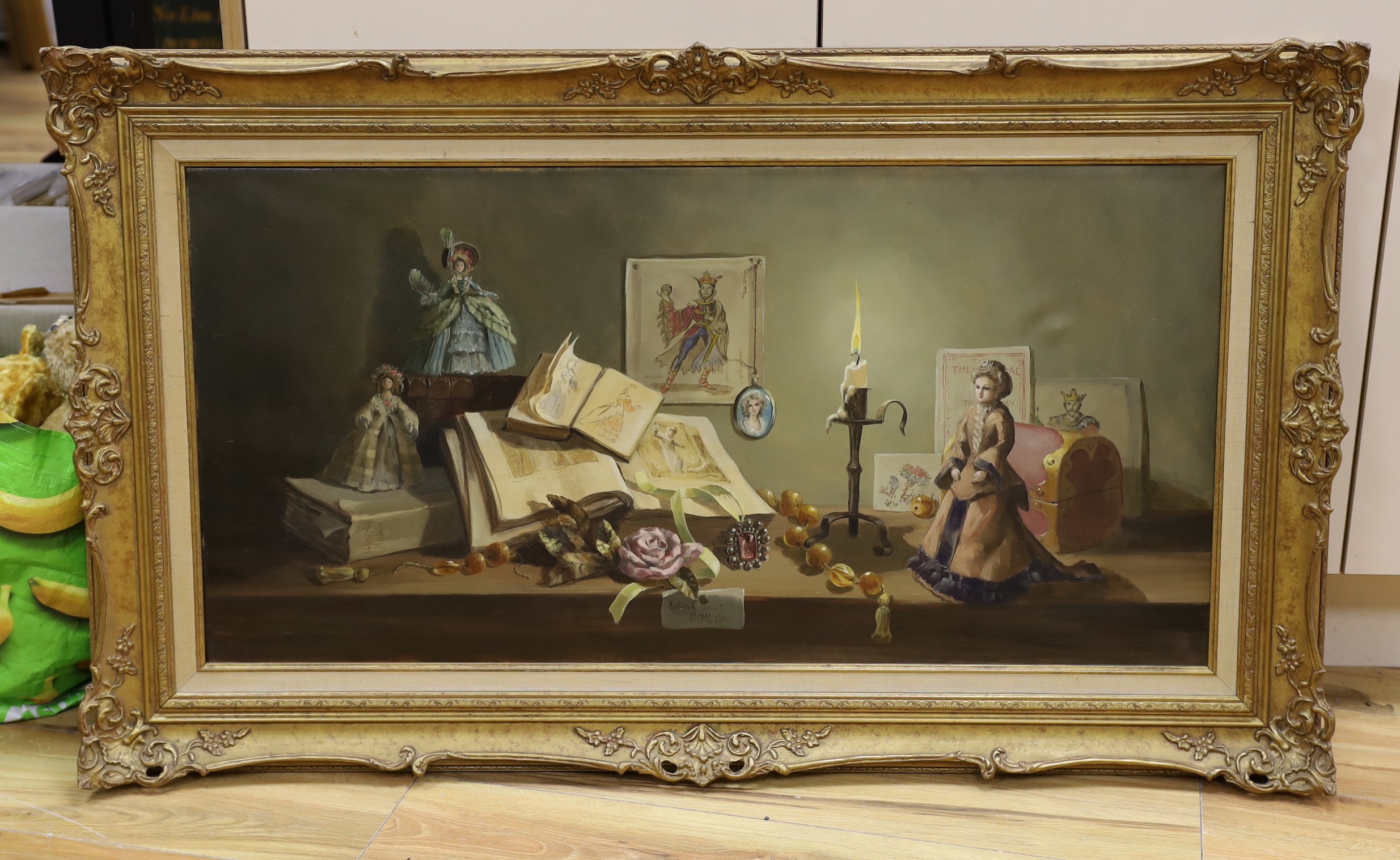 Deborah Jones (1921-2012), oil on canvas, Still life with books, dolls and candle, signed and dated 1974, label verso, 45 x 91cm.